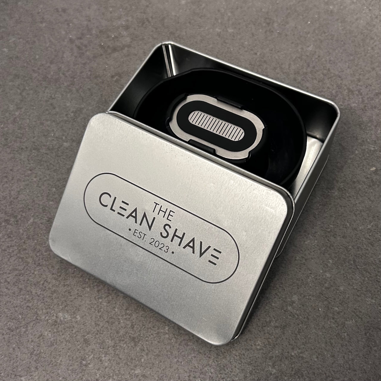 A Razor Rinser in its premium case with embossed The Clean Shave Co logo.