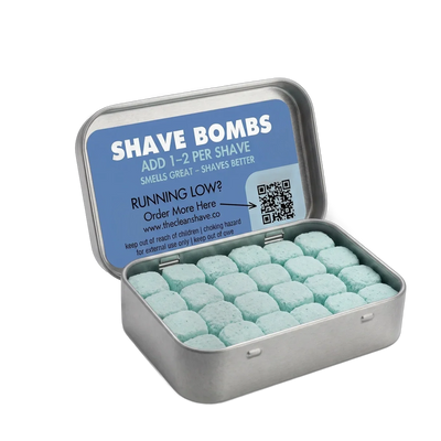 An open tin of teal Shave Bomb tablets
