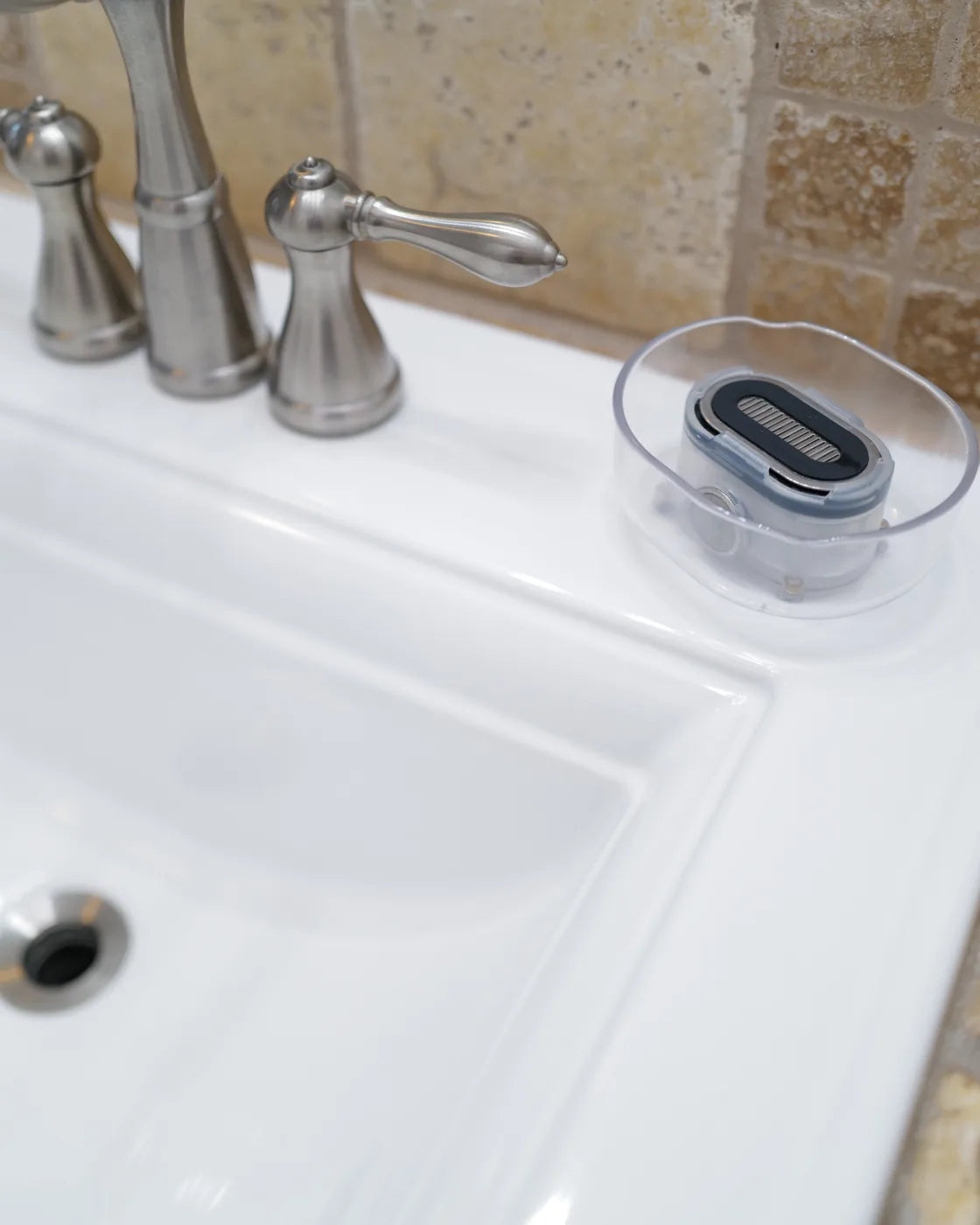 The Clear Razor Rinser® resting beside the sink.