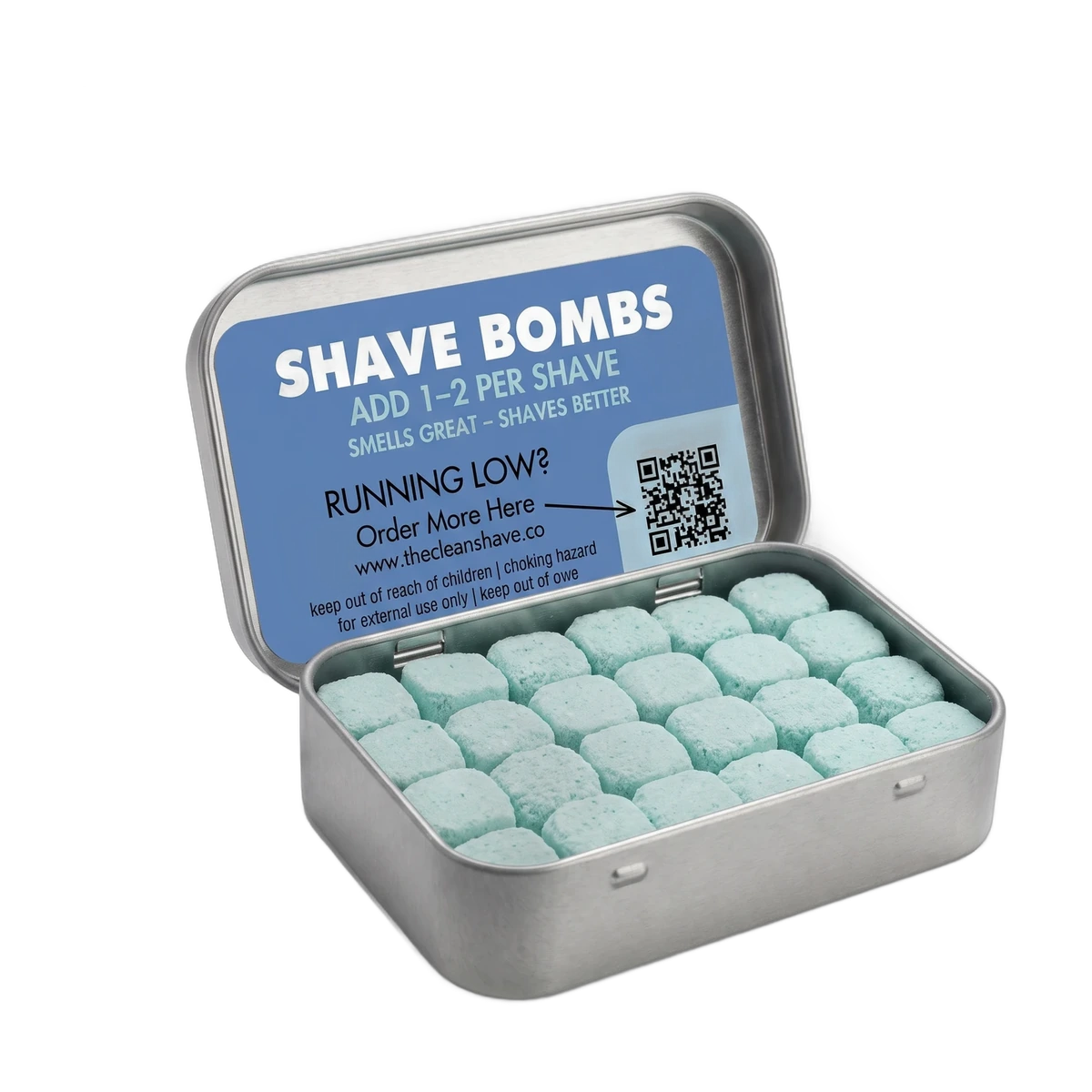 An open tin of teal shave bomb tablets